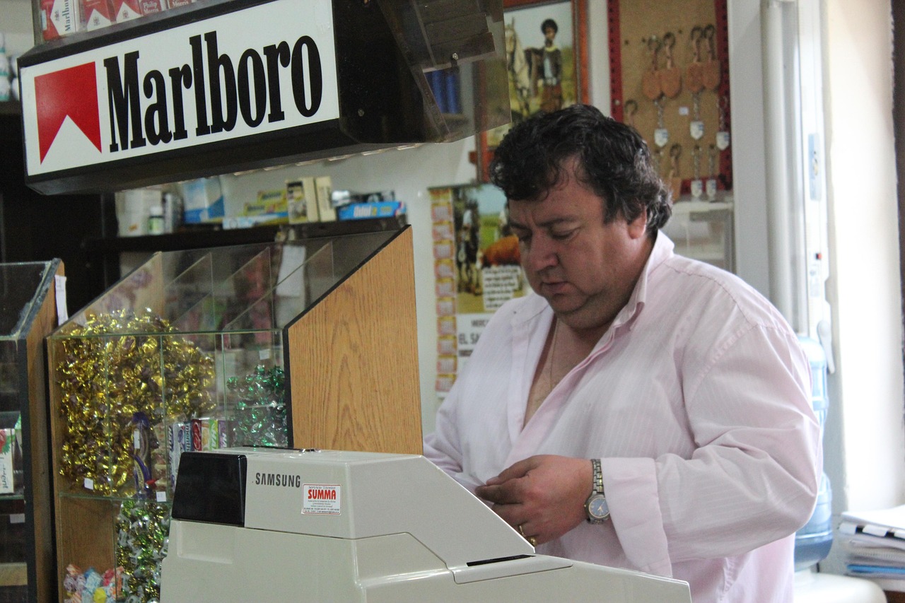 Immagine di un tabaccaio che sorride mentre mostra un Gratta e Vinci vincente.